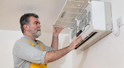 man installing A/C unit