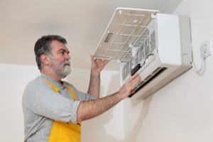 man installing A/C unit